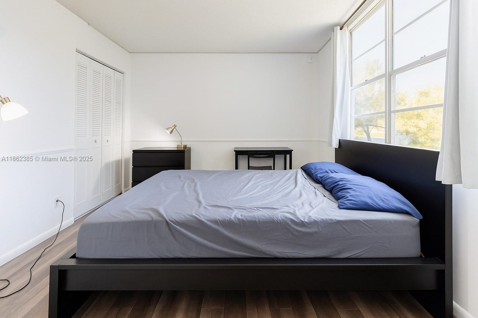 9330 Lagoon Place, Unit 206 Davie, FL 33324 - Photo 10 of 17 a bedroom with a bed and a window