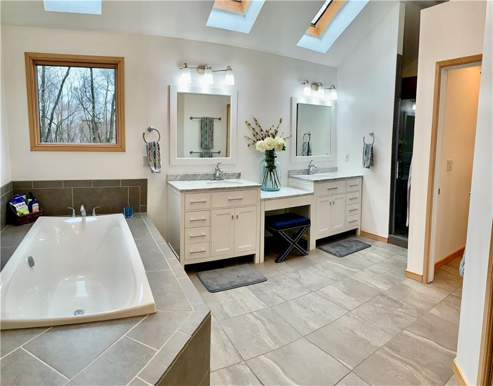 3450 Pinewood Road Irwin, PA 15642 - Photo 17 of 25 large master bath features a deep soaking tub, double vanity areas with marble sink tops, large walk in shower w/rain shower head, private toilet and an absolutely massive closet!!