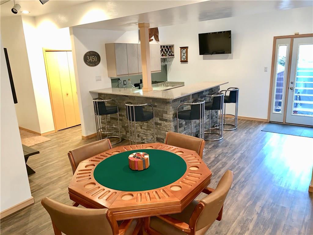 3450 Pinewood Road Irwin, PA 15642 - Photo 21 of 25 a second lower level game room featuring a stacked stone wet bar w/mini fridge and granite bar top, wine storage, a full bath, propane fireplace, and walk out to backyard. Magnificent!!