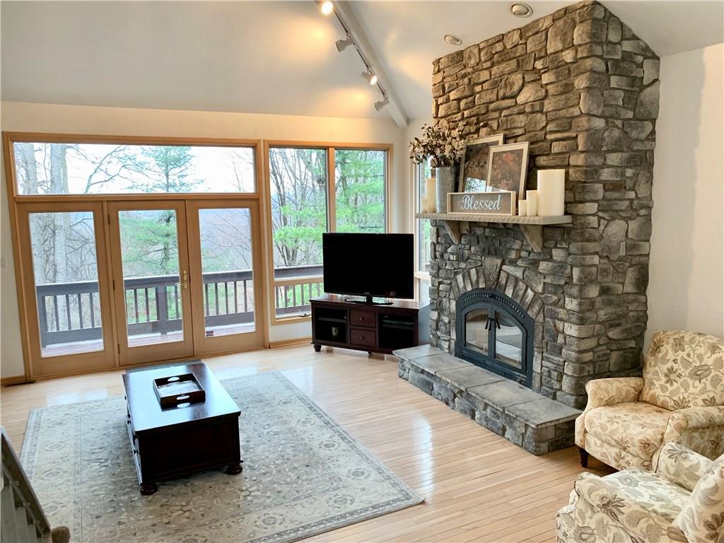 3450 Pinewood Road Irwin, PA 15642 - Photo 10 of 25 check out this oversized stone wood burning fireplace! Picture relaxing by the fire while watching the snow fall outside of those gorgeous floor to ceiling windows! Serenity at its best!
