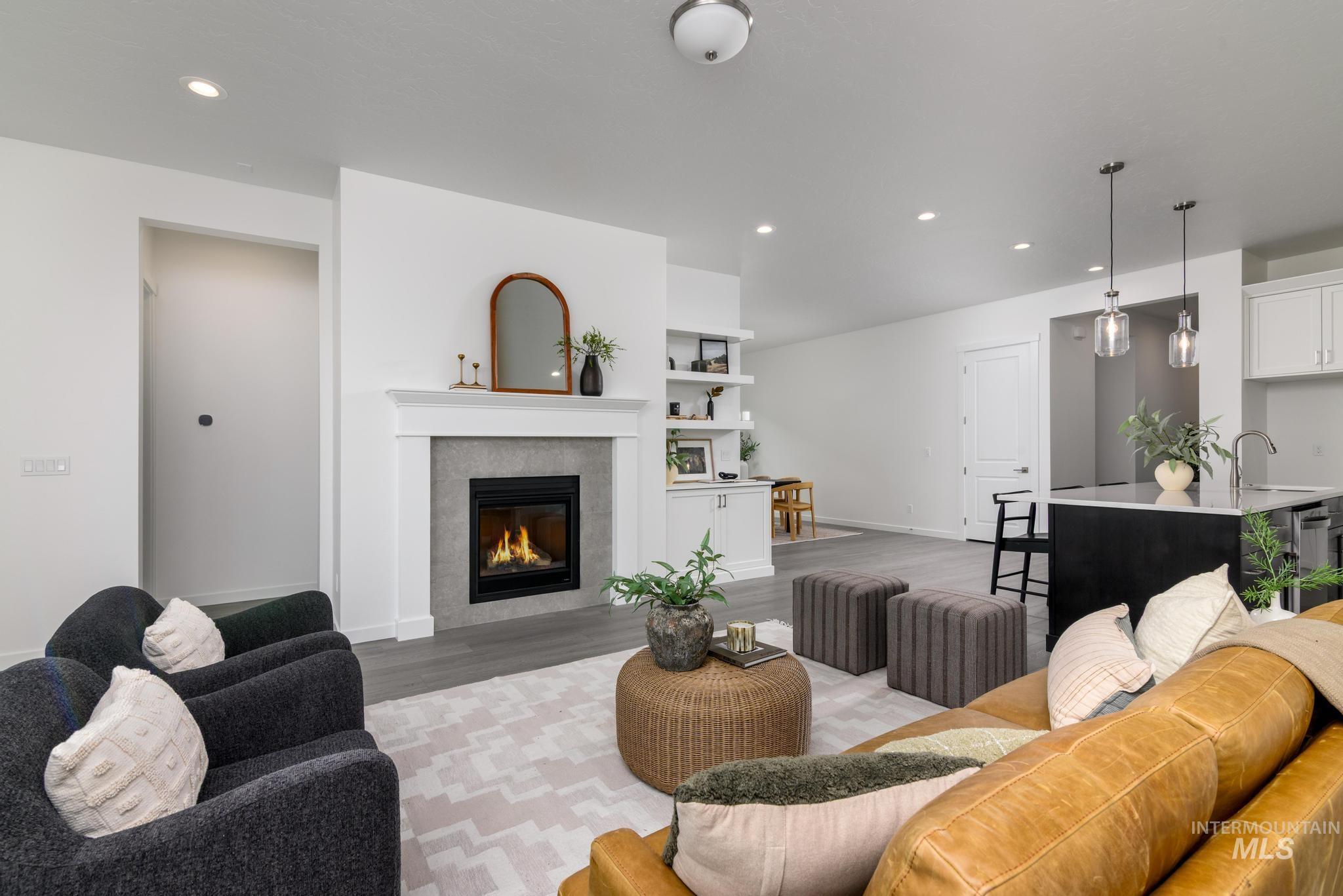 8554 West Fanning Street Star, ID 83669 - Photo 3 of 11 Living area featuring recessed lighting, a tile fireplace, wood finished floors, and built in features