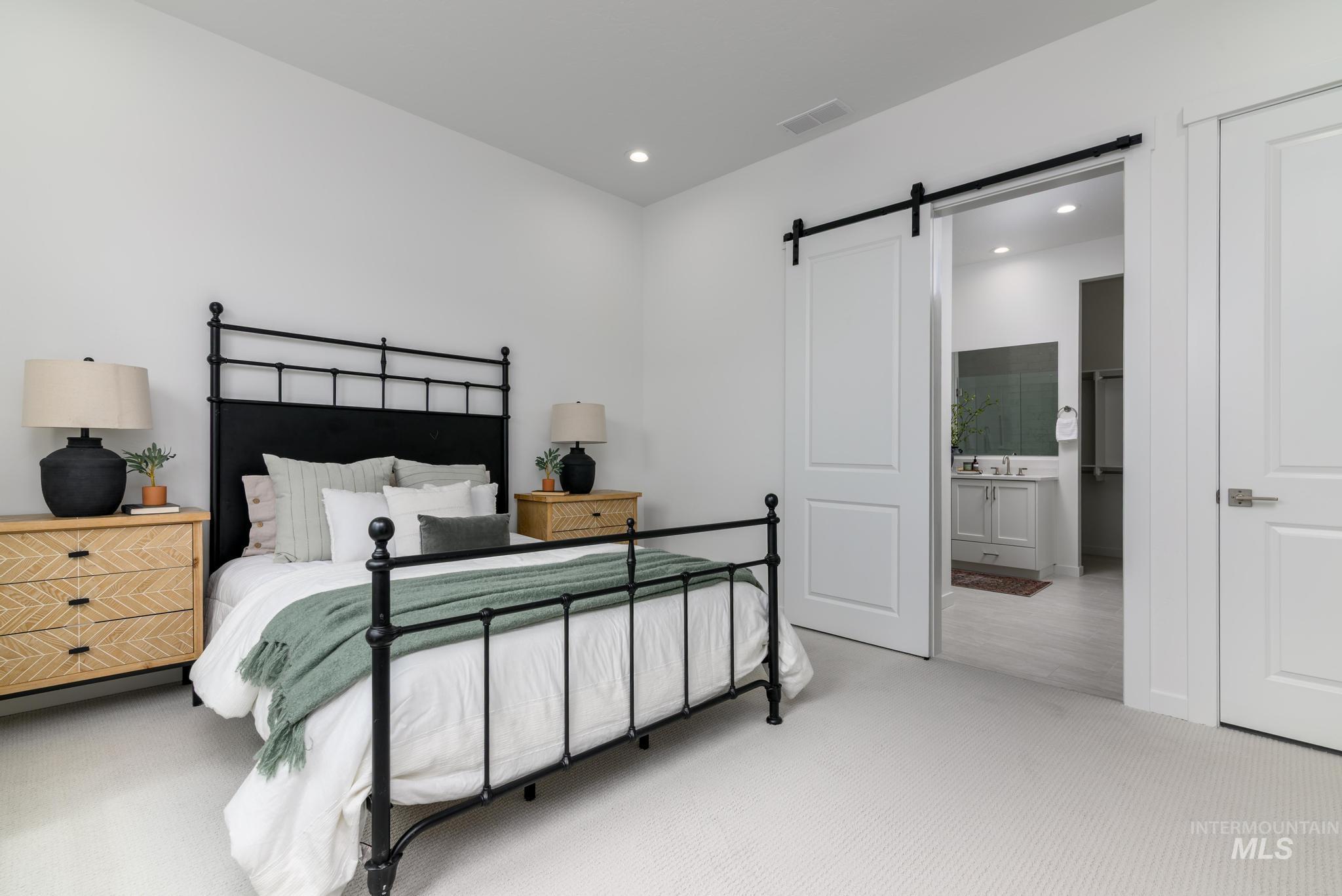 8554 West Fanning Street Star, ID 83669 - Photo 6 of 11 Carpeted bedroom with a barn door, recessed lighting, and ensuite bath