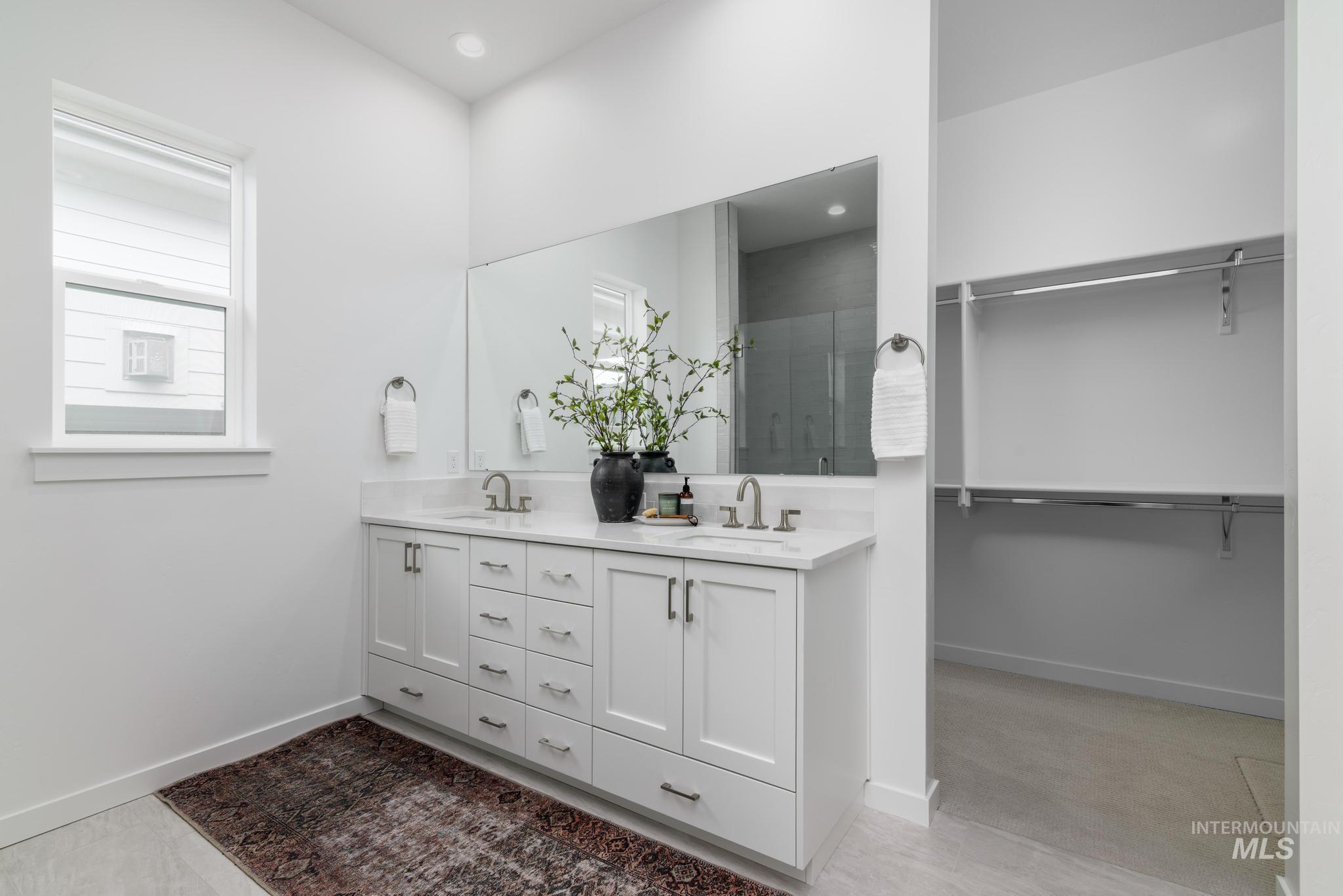 8554 West Fanning Street Star, ID 83669 - Photo 7 of 11 Full bathroom with a spacious closet, double vanity, and a shower stall