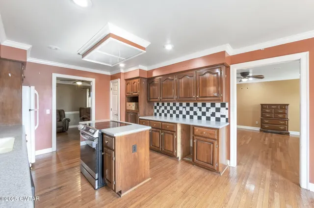a open kitchen with a sink and chairs