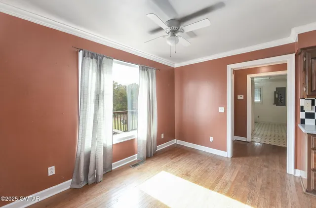 wooden floor in an empty room with a window