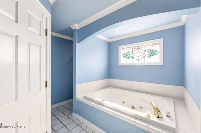 a bath tub sitting in a bathroom next to a window