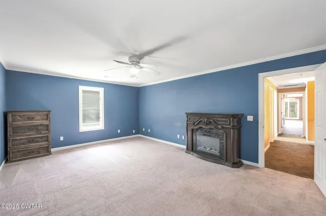 a view of a livingroom with a fireplace and window