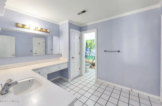 a spacious bathroom with a granite countertop sink and a mirror