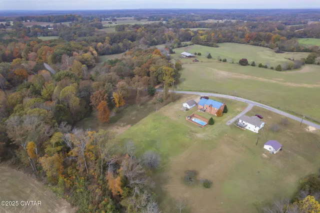 an aerial view of a houses with a lake view
