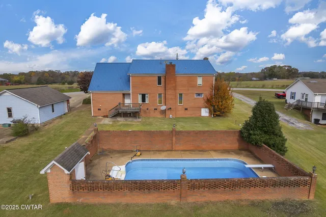a view of a pool with a yard