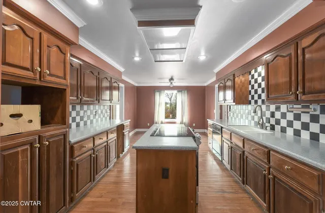 a kitchen with stainless steel appliances granite countertop lots of counter top space and wooden floor