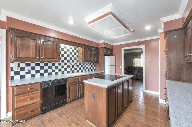 a kitchen with stainless steel appliances granite countertop a stove and a sink