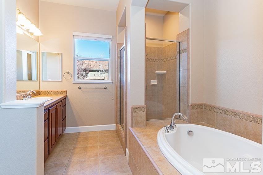 2635 Trail Rider Drive Reno, NV 89521 - Photo 17 of 25 a bathroom with a tub sink and mirror