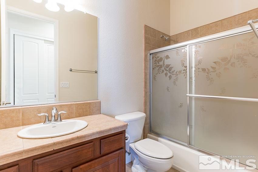 2635 Trail Rider Drive Reno, NV 89521 - Photo 19 of 25 a bathroom with a granite countertop sink toilet and shower