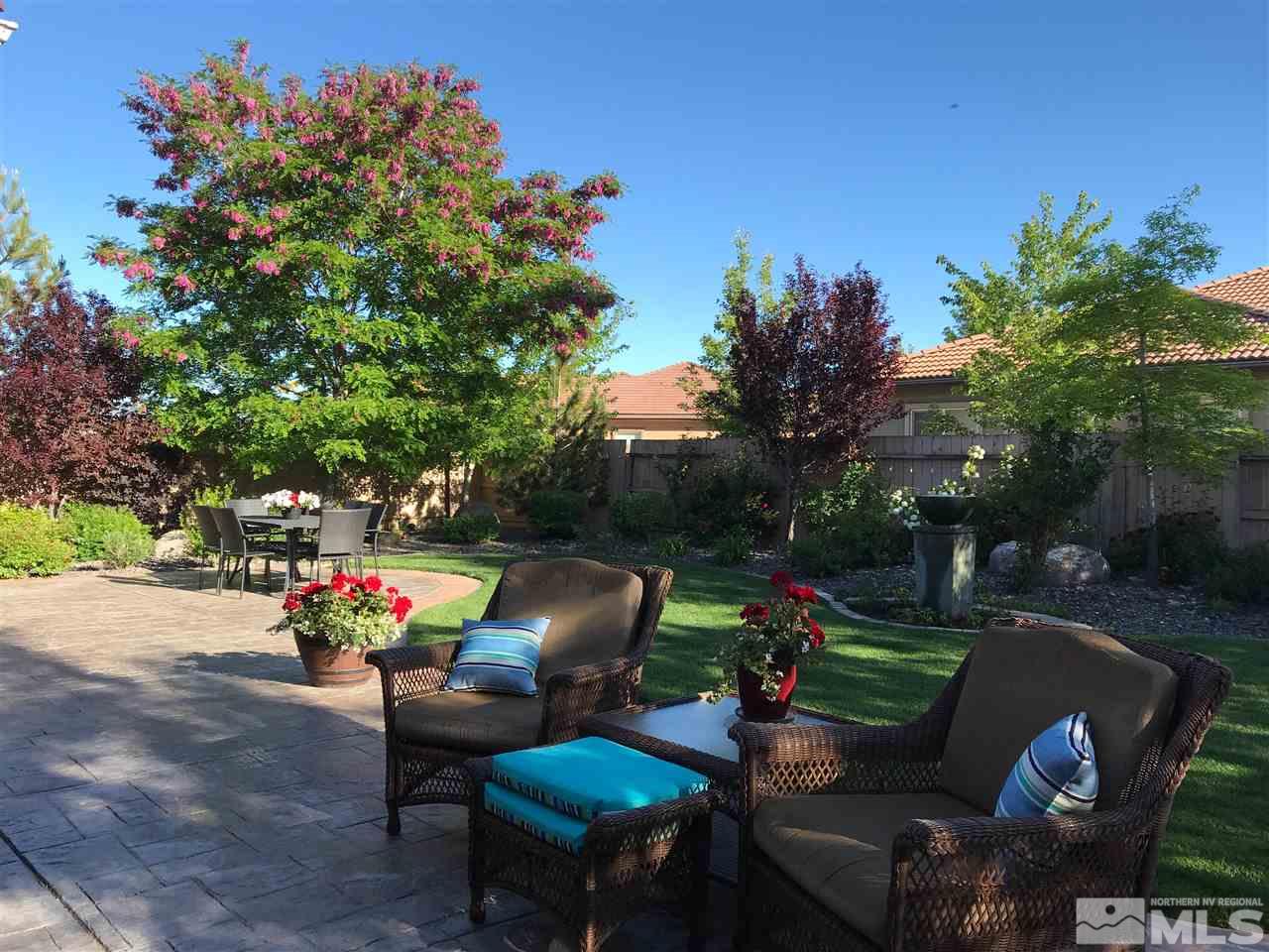 2635 Trail Rider Drive Reno, NV 89521 - Photo 21 of 25 a view of a backyard with couches table and chairs and potted plants
