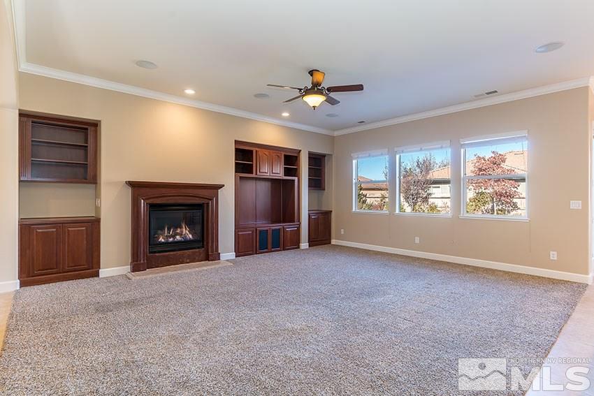 2635 Trail Rider Drive Reno, NV 89521 - Photo 7 of 25 an empty room with windows and fireplace
