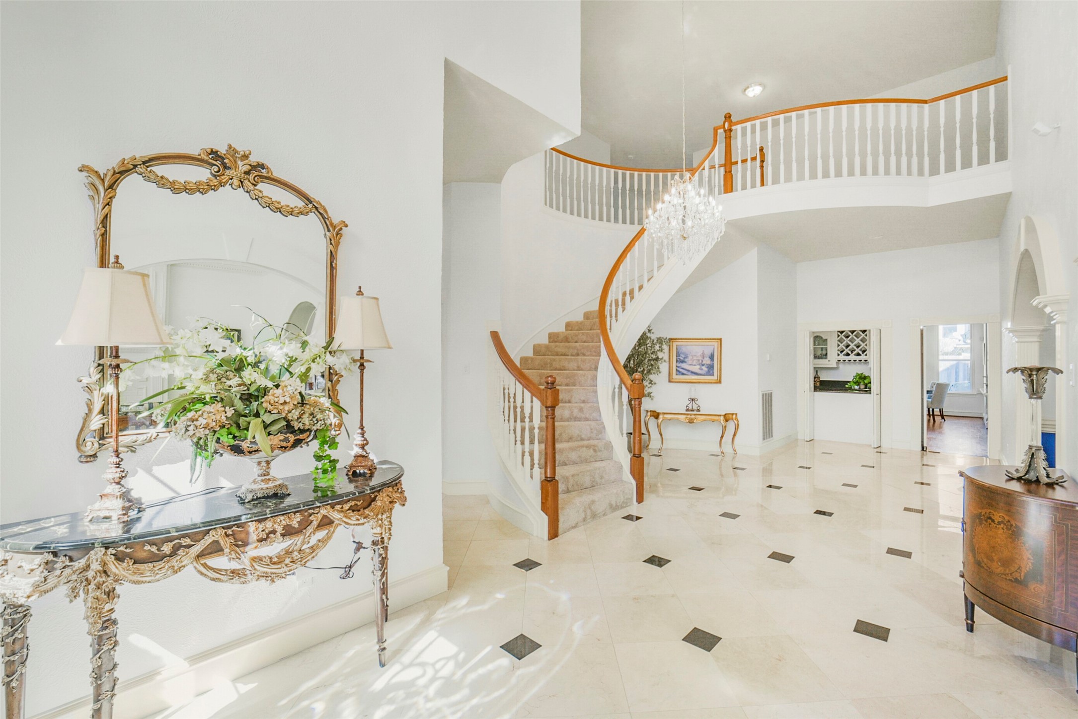 17302 Atherington Place Spring, TX 77379 - Photo 6 of 50 Marble flooring and a curved staircase shine in the entryway, creating a welcoming and elegant first impression. The polished marble adds a touch of luxury, while the curved staircase offers a sense of sophistication and movement.