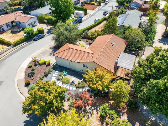 an aerial view of a house with a yard and garden