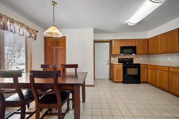 a kitchen with stainless steel appliances granite countertop a refrigerator a stove top oven a sink and dishwasher