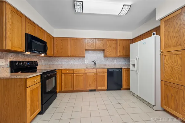 a dining room with furniture a window and kitchen view