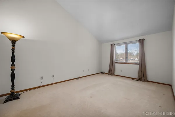 a spacious bathroom with a granite countertop sink a mirror and a shower