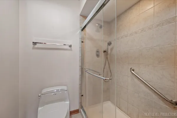 a bathroom with a granite countertop sink a toilet and shower