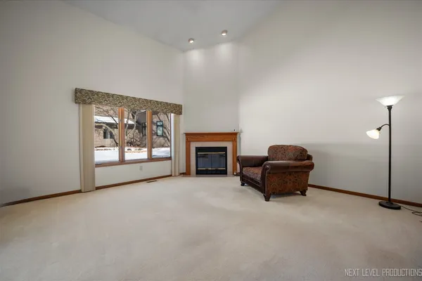 a view of an empty room with stairs and a couch