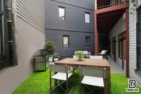 a dining room with furniture and a potted plant