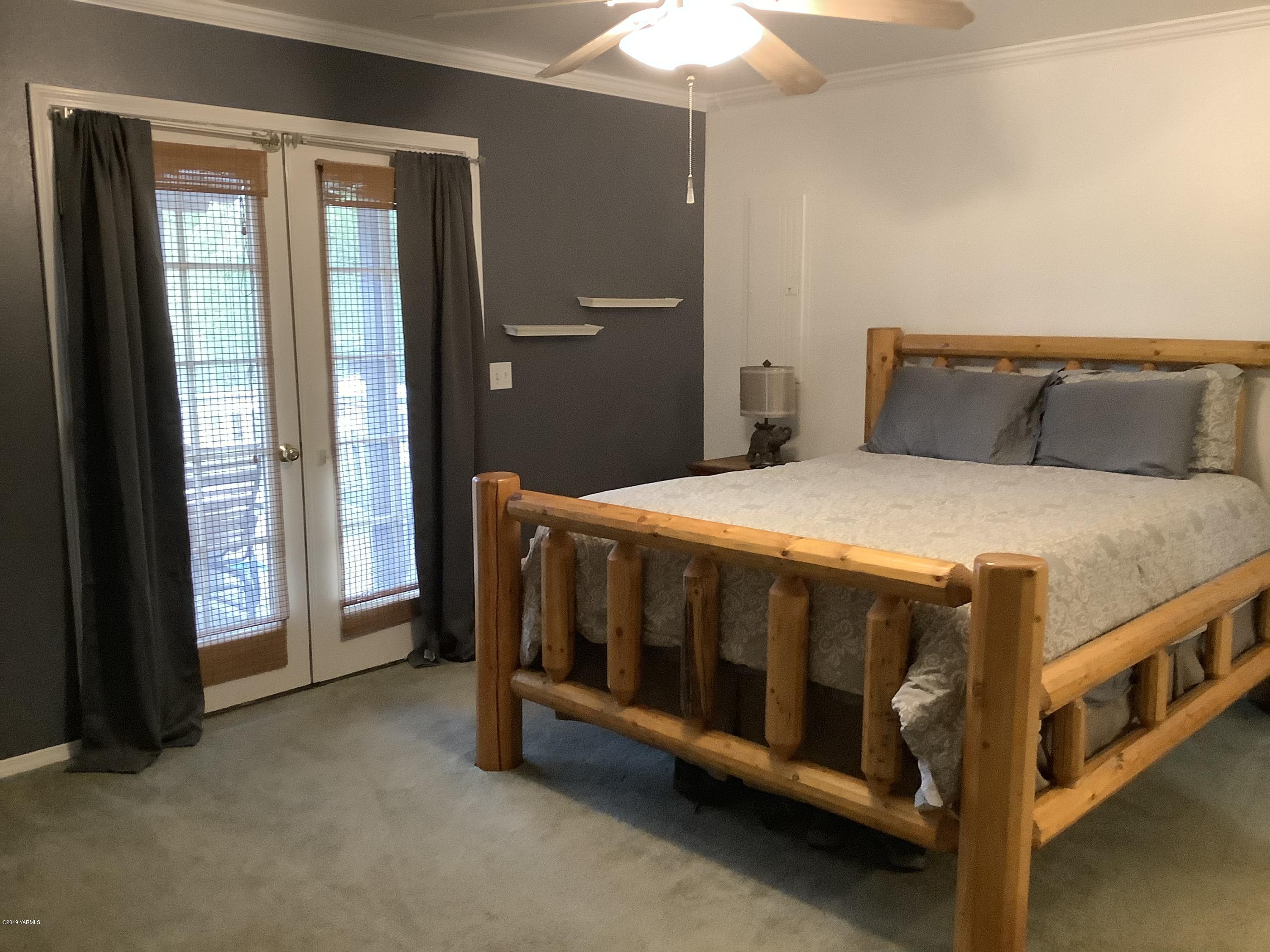 15021 Douglas Road Yakima, WA 98908 - Photo 13 of 35 a bedroom with a bed and a baby crib