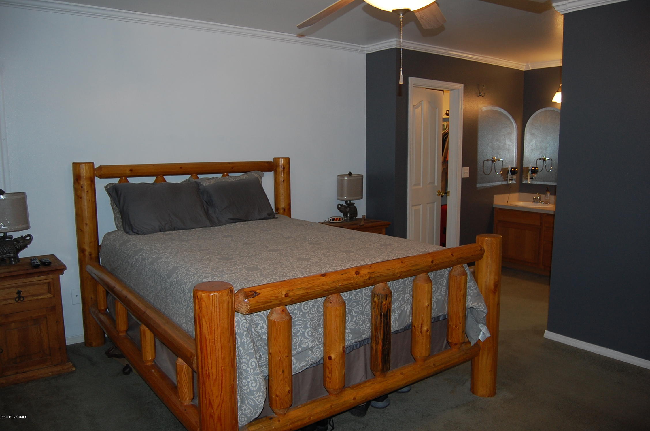 15021 Douglas Road Yakima, WA 98908 - Photo 14 of 35 a bed sitting in a bedroom next to a bathroom sink