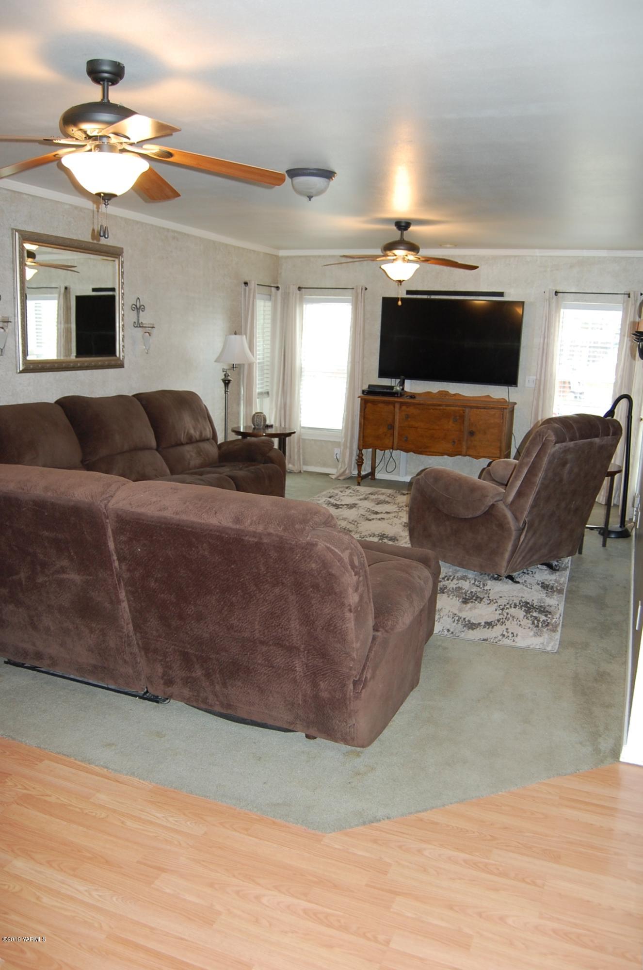 15021 Douglas Road Yakima, WA 98908 - Photo 6 of 35 a living room with furniture a fireplace and a flat screen tv