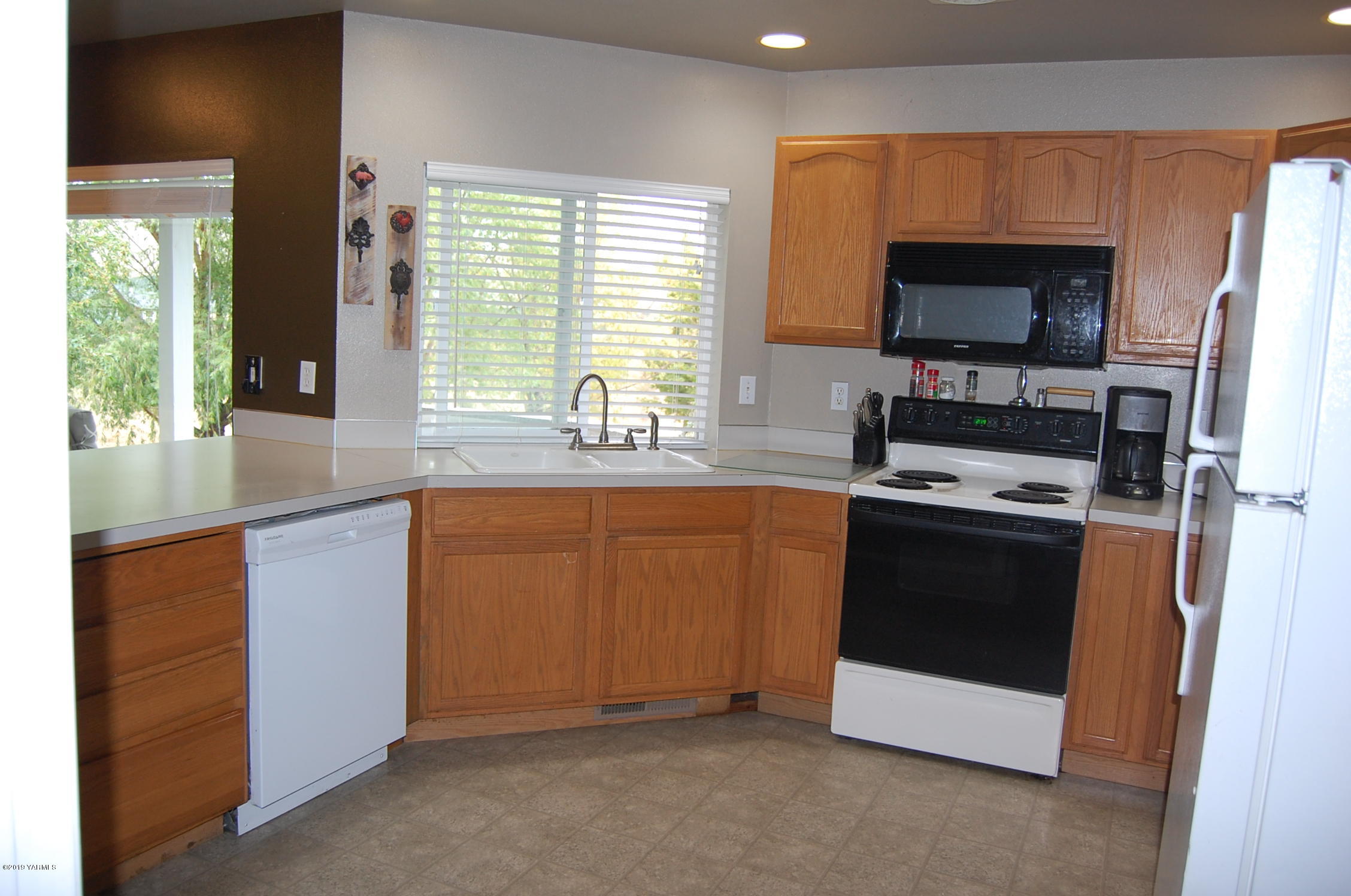 15021 Douglas Road Yakima, WA 98908 - Photo 9 of 35 a kitchen with stainless steel appliances a stove sink and microwave
