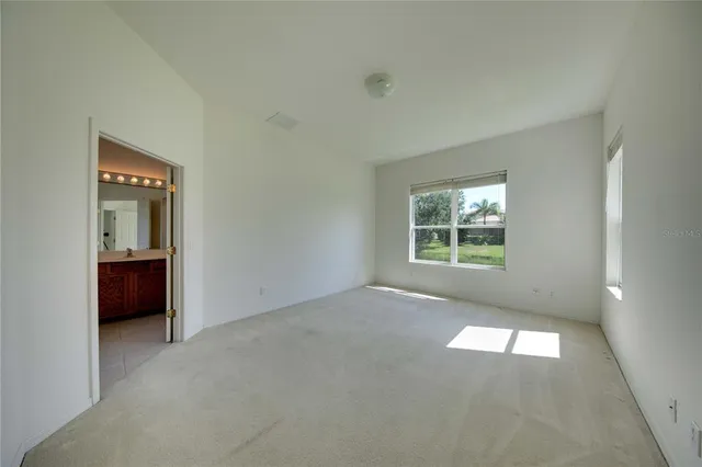 an empty room with windows and entrance