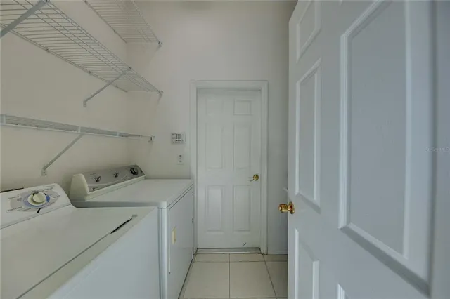 a large kitchen with stainless steel appliances a large counter top a stove and a sink