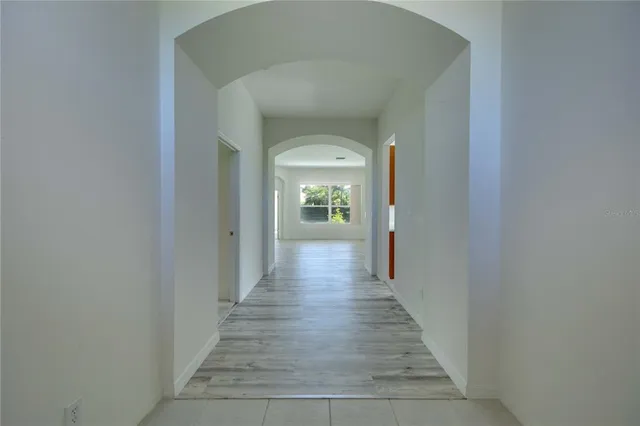 a view of a hallway with wooden floor