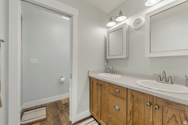 18573 South Marsh Valley Road Downey, ID 83234 - Photo 15 of 32 Full bathroom featuring double vanity and dark wood finished floors