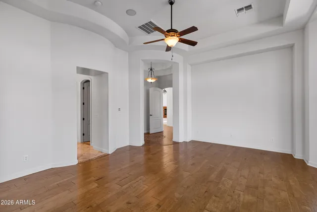 a view of an empty room with a ceiling fan