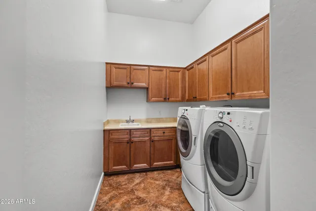 a utility room with sink dryer and washer