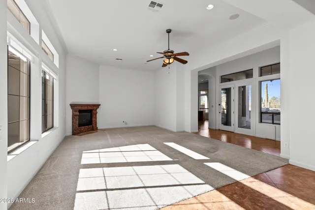 a view of a livingroom with a dinning area ceiling fan and window