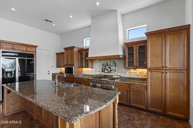 a kitchen with stainless steel appliances granite countertop a sink stove and refrigerator