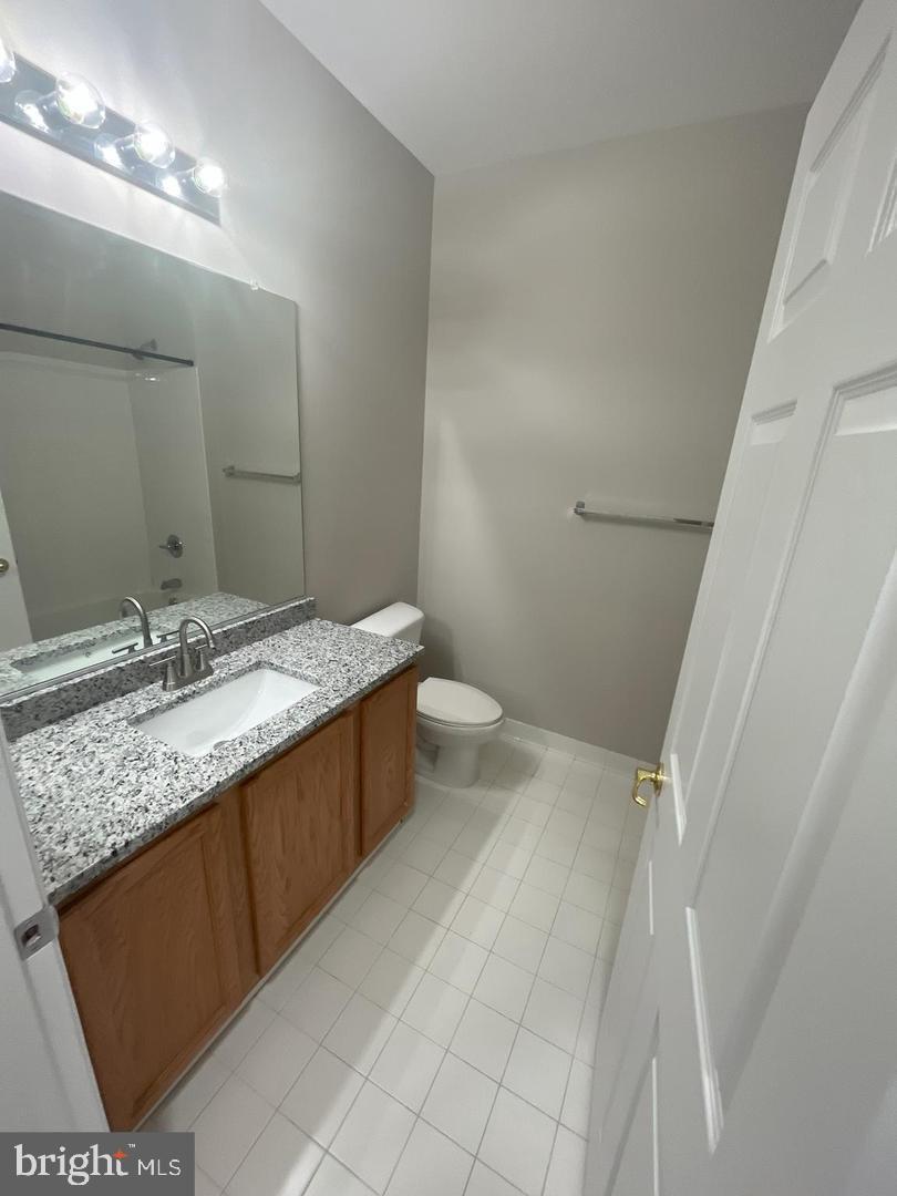 1321 Karen Boulevard, Unit 302 Capitol Heights, MD 20743 - Photo 6 of 14 a bathroom with a granite countertop sink and a mirror