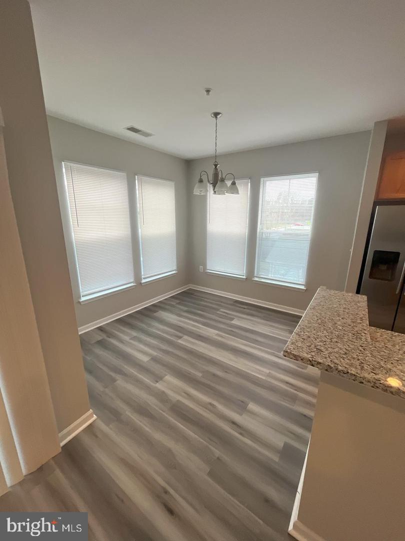 1321 Karen Boulevard, Unit 302 Capitol Heights, MD 20743 - Photo 7 of 14 a bedroom with a bed and a large window