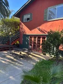 a view of a house with backyard sitting area and swimming pool
