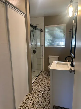 a bathroom with a sink toilet and shower