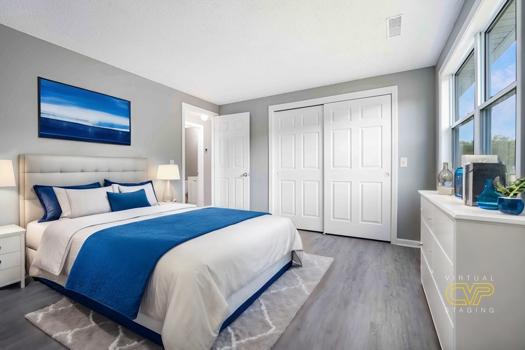 1475 Braley Road, Unit 22 New Bedford, MA 02745 - Photo 14 of 19 a spacious bedroom with a bed and a wooden floor