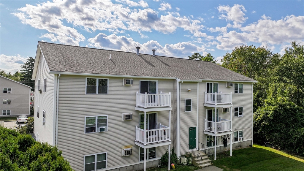 1475 Braley Road, Unit 22 New Bedford, MA 02745 - Photo 3 of 19 a aerial view of a house next to a yard