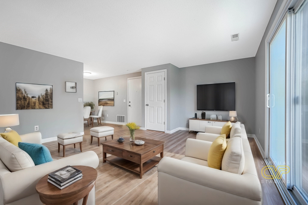 1475 Braley Road, Unit 22 New Bedford, MA 02745 - Photo 6 of 19 a living room with furniture and a flat screen tv