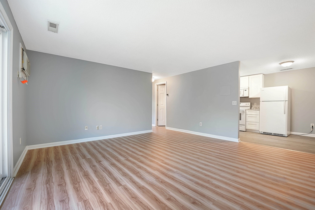 1475 Braley Road, Unit 22 New Bedford, MA 02745 - Photo 8 of 19 a view of an empty room with wooden floor