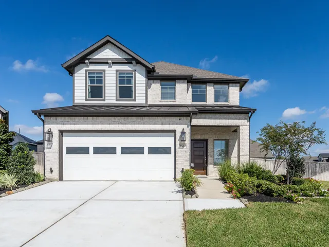 a kitchen with stainless steel appliances granite countertop a stove top oven a sink a dining table and chairs