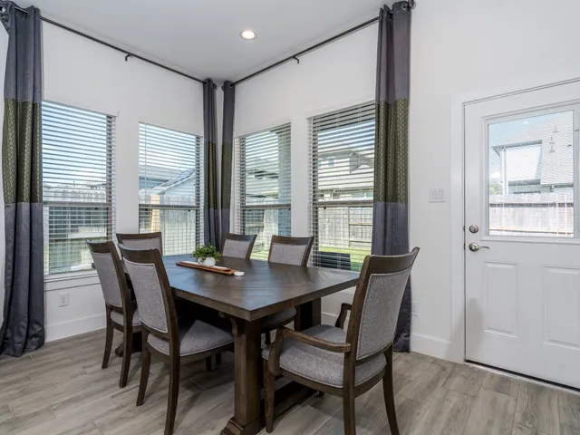 a living room with furniture and large windows